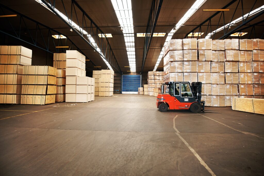 Your goods will be in a safe place. A large warehouse storing big boxes with a forklift.
